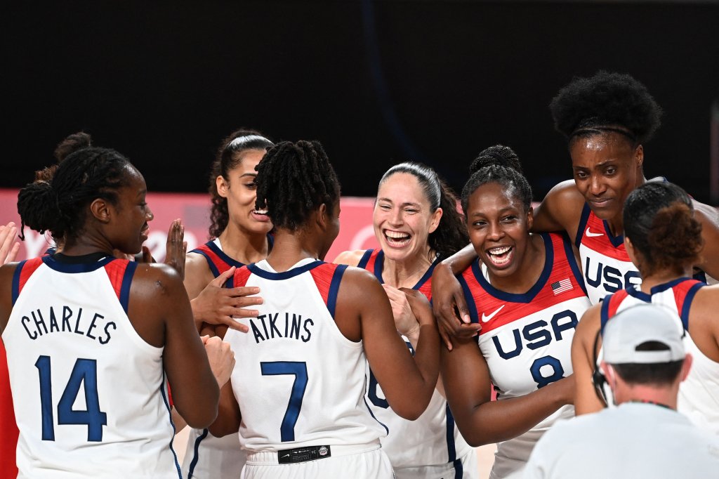 USA's players celebrate their victory at the end of the women's final basketball match between USA and Japan during the Tokyo 2020 Olympic Games at the Saitama Super Arena in Saitama on August 8, 2021.
