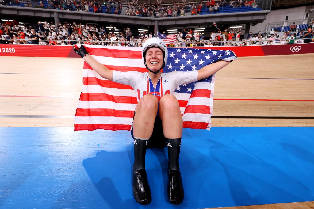 Jennifer Valente of Team United States celebrates winning the gold medal while holding the flag of her country during the Women's Omnium points race, 4 round of 4 of the track cycling on day sixteen of the Tokyo 2020 Olympic Games at Izu Velodrome on Aug. 8, 2021 in Izu, Shizuoka, Japan.