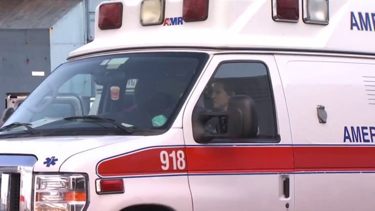Ambulance rolls over near hospital entrance, trapping 2 EMTs inside