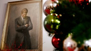 FILE – In this Nov. 30, 2006, file photo, a portrait of former President John F. Kennedy, framed by Christmas decorations, hangs in the White House in Washington. A copy of Kennedy’s 1961 letter reassuring an 8-year-old Michigan girl, who had written him concerned that Santa would be killed if Russia tested a nuclear bomb at the North Pole, is being featured in December 2019 at the JFK Presidential Library and Museum in Boston. (AP Photo/Ron Edmonds, File)