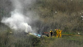 Firefighters work the scene of a helicopter crash