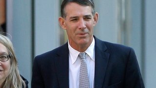 Michael Center, former men's tennis coach at the University of Texas at Austin arrives, Monday, Feb. 24, 2020, at federal court in Boston for sentencing, in a nationwide college admissions bribery scandal.