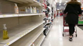 FILE - In this Tuesday, March 3, 2020 file photo, shelves that held hand sanitizer and hand soap are mostly empty at a store in Jersey City, N.J.