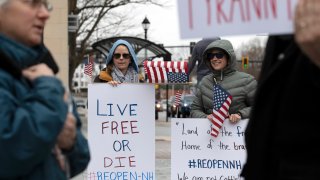 People demonstrate against the government mandated lockdown due to concern about COVID-19 at the State House, Saturday, April 18, 2020, in Concord, N.H.