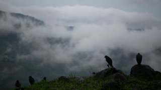 In this Sunday, May 31, 2020 photo, rain clouds hover over mountains during tropical storm Amanda in Barberena, eastern Guatemala. The first tropical storm of the Eastern Pacific season drenched parts of Central America on Sunday and officials in El Salvador said at least seven people had died in flooding.