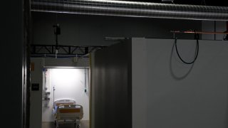 FILE - In this May 11, 2020, file photo light shines in a patient pod at a temporary alternate care site constructed in response to the coronavirus outbreak inside the Walter E. Washington Convention Center in Washington.