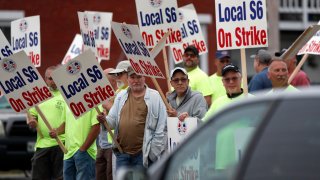 Shipbuilders picket outside an entrance to Bath Iron Works, Monday, June 22, 2020, in Bath, Maine. Thousands of workers went on strike against one of the Navy’s largest shipbuilders Monday after rejecting a three-year contract.