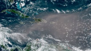 This satellite photo provided by the National Oceanic and Atmospheric Administration, NOAA, shows a cloud of dust coming from the Sahara desert arriving to the Caribbean Monday, June 22, 2020. The massive cloud of dust is blanketing the Caribbean as it heads to the U.S. with a size and concentration level that meteorologists say hasn't been seen in roughly half a century.