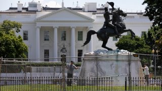 The base of the statue of former president Andrew Jackson is power washed inside a newly closed Lafayette Park, Wednesday, June 24, 2020, in Washington.