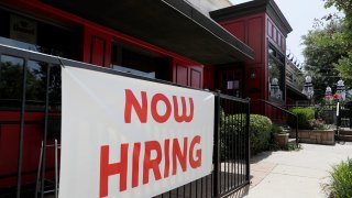 In this June 26, 2020, file photo, Sherlock's, a pub in Addison, Texas, has a sign out front that reads, "Now Hiring."