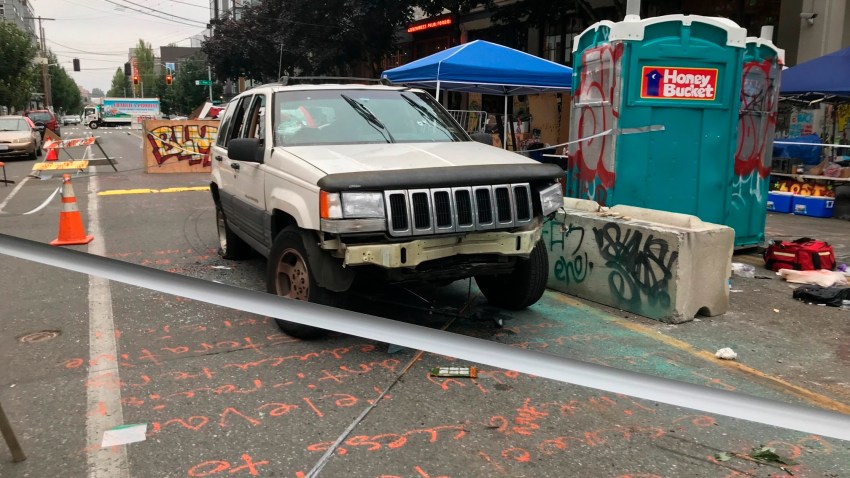 A car sits in the Capitol Hill Organized Protest zone following a shooting in Seattle early Monday, June 29, 2020
