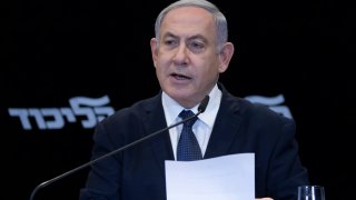 Israeli Prime Minister Benjamin Netanyahu reads a statement in Jerusalem, Wednesday, Jan. 1, 2020.