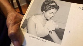 In this March 4, 2020 photo, Roslyn Pope shows her Spelman College yearbook at her home in Atlanta. As a 21-year-old Spelman senior in March 1960, Pope wrote "An Appeal for Human Rights," a document that made the case for the Atlanta Student Movement, a nonviolent campaign of boycotts and sit-ins by black college students that protested racial segregation in education, jobs, housing, voting, hospitals, movies, concerts, restaurants and law enforcement.