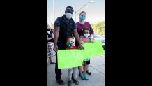 Aaron, Joy, Isaac and Elena Onyango from Boston's Mattapan neighborhood at a Black Lives Matter vigil in West Roxbury on Monday, June 8, 2020.