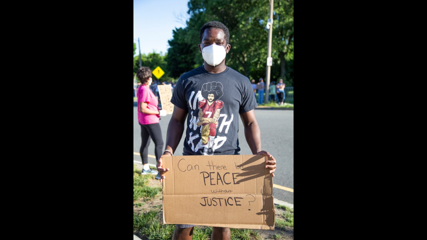 West Roxbury resident Pascale Opiyo, who is originally from Kenya, at a Black Lives Matter vigil in West Roxbury on Monday, June 8, 2020.