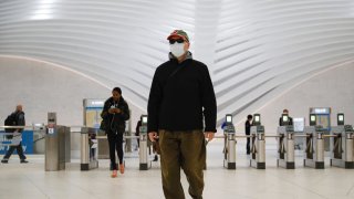 A commuter wears a face mask in the New York City transit system, Monday, March 9, 2020, in New York.