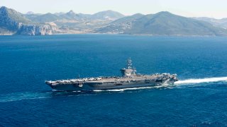In this June 13, 2016, file photo provided by the U.S. Navy, the aircraft carrier USS Dwight D. Eisenhower (CVN 69) transits the Strait of Gibraltar into the Mediterranean Sea.