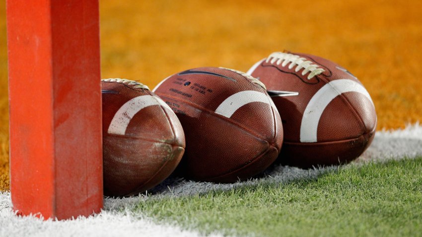 Footballs on a field.