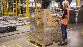 an employee checks packages at the Amazon fulfillment center