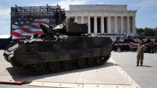 Members of the U.S. Army park an Bradley fighting vehicle in front of the Lincoln Memorial