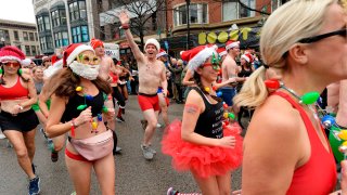 Runners start the race, making their way down Boylston Street during the 20th Annual Santa Speedo Run in Boston on Dec. 14, 2019.