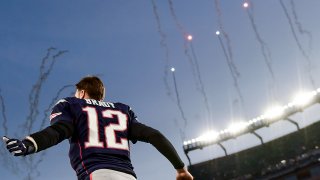 Tom Brady runs onto the field at Gillette Stadium