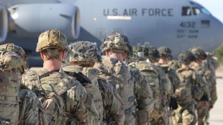This Jan. 1, 2020, handout picture released by the U.S Army shows U.S. Army Paratroopers assigned to the 2nd Battalion, 504th Parachute Infantry Regiment, 1st Brigade Combat Team, 82nd Airborne Division, deploy from Pope Army Airfield, North Carolina on January 1, 2020.