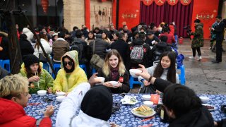 overseas students attend a long-table feast marking the upcoming Chinese Lunar New Year