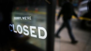 BROOKLINE, MA – MARCH 24: A business posts a sign alerting its customers that it is closed in Coolidge Corner in Brookline, MA during the COVID-19 pandemic. The city empties out a day after Governor Charlie Baker issued a stay at home advisory for all non-essential workers as a way to reduce the spread of coronavirus and flatten the COVID-19 curve.  (Photo by Lane Turner/The Boston Globe via Getty Images)