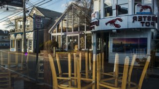 Chairs sit on top of tables inside a closed restaurant on Cape Cod in downtown Provincetown, Massachusetts, U.S., on Wednesday, April 22, 2020. Thousands of locals signed a petition calling for bridges to be closed to prevent visitors from coming to the area to stop the spread of Covid-19, Business Insider reported. Photographer: Adam Glanzman/Bloomberg via Getty Images