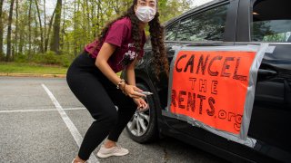 A demonstrator prepares for a national day of car protest to cancel the rents drive through Washington, D.C., to call for the cancellation of rents, mortgages and related utility bills, for the duration of the COVID-19 crisis in Rock Creek Park on Saturday, April 25, 2020.