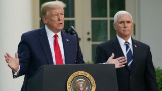 President Donald Trump speaks as Vice President Mike Pence looks on during a news conference on the novel coronavirus, COVID-19, in the Rose Garden of the White House in Washington on April 27, 2020.