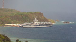 In this April 27, 2020, file photo, the aircraft carrier U.S.S Theodore Roosevelt is seen docked at Naval Base Guam in Apra Harbor amid the coronavirus pandemic.