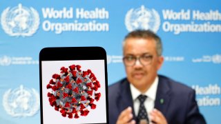 In this photo illustration the World Health Organization Director General Tedros Adhanom Ghebreyesus is seen on a screen of pc and a coronavirus image displayed on a screen of a smartphone in Kiev, Ukraine.