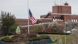 HOLYOKE, MA – APRIL 29: An American flag flies at half-mast outside the Holyoke Soldiers’ Home on April 29, 2020 in Holyoke, Massachusetts. In one of the deadliest known COVID-19 outbreaks at a long-term care center in the U.S., more than 70 residents have reportedly died at the veteran living facility as dozens more residents and employees have tested positive for the virus. (Photo by Matthew Cavanaugh/Getty Images)