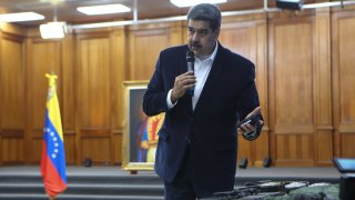 Venezuelan President, Nicolas Maduro displays seized armament and passports after a meeting with members of the Armed Forces in Caracas, Venezuela on May 4, 2020. Venezuela's President Nicolas Maduro confirmed the detention of two US "mercenaries" among 13 attackers involved in Sunday's two failed maritime raids.