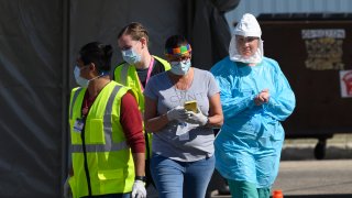 Medical workers administered drive-up COVID-19 tests Saturday outside the Sanford Worthington Clinic. On Friday, their fears were confirmed: At least 19 cases were confirmed at the JBS pork plant here, an hour east of the Smithfield Foods pork plant in Sioux Falls, which was shut down last week when nearly 300 workers were infected with the disease.