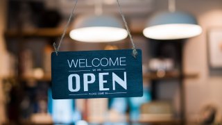 Store open sign hanging on the window. FILE