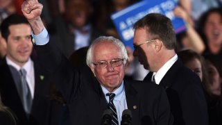 TOPSHOT – US Democratic presidential candidate Bernie Sanders celebrates his victory during the primary night rally in Concord, New Hampshire, on February 9, 2016.
Self-described democratic socialist Bernie Sanders and political novice Donald Trump won New Hampshire’s presidential primaries Tuesday, US media projected, turning the American political establishment on its head early in the long nominations battle. / AFP / Jewel Samad (Photo credit should read JEWEL SAMAD/AFP via Getty Images)