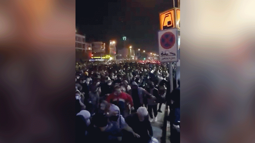 This image from a Sunday, Jan. 12, 2020 video provided by the New York-based Center for Human Rights in Iran shows a crowd fleeing police near Azadi, or Freedom, Square in Tehran, Iran.