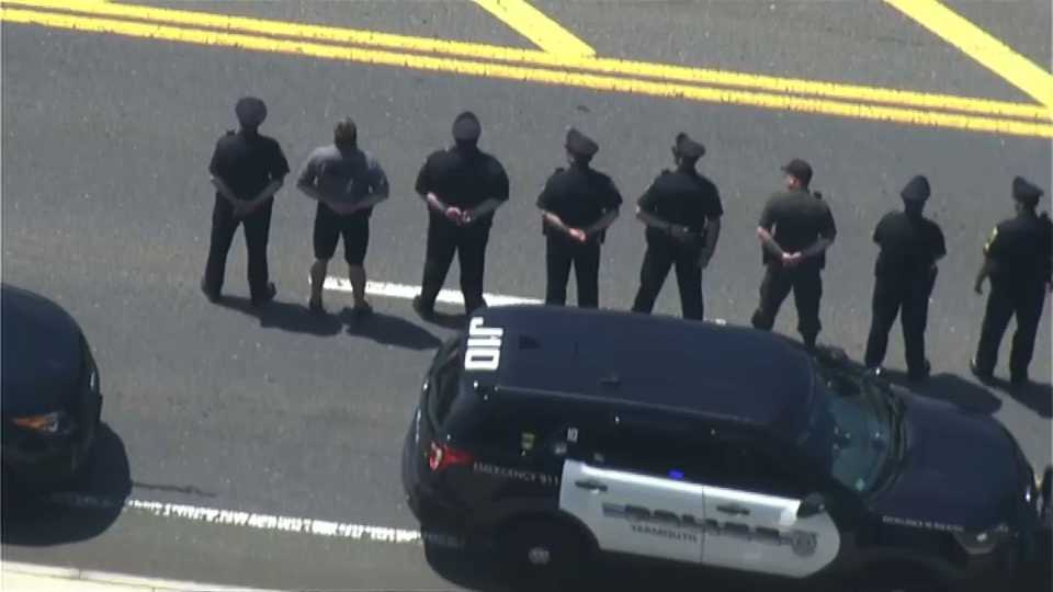 Police officers line the street as slain Weymouth Police Officer Michael Chesna is transported to the medical examiner.