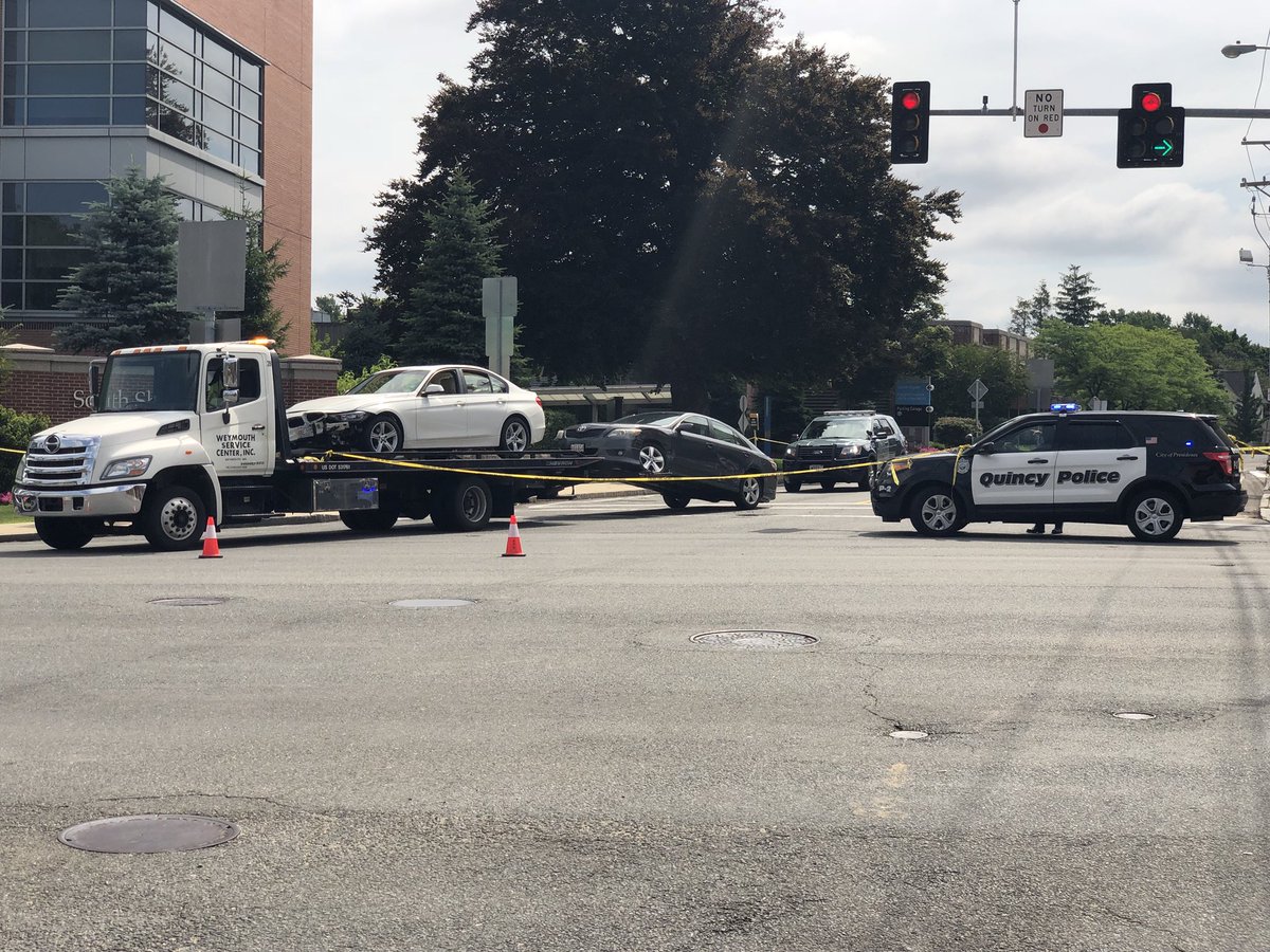 Two cars were damaged in the gunfire on Sunday, seen above on a tow truck near South Shore Hospital.