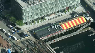 Police in Boston's Seaport District after a body was found outside the Barking Crab restaurant