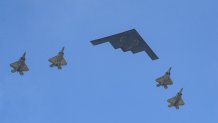 a military bomber and four fighter jets fly over boston on july 4