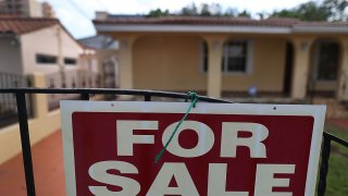 File photo - A for sale sign is posted in front of a home on Nov. 17, 2016, in Miami, Florida.