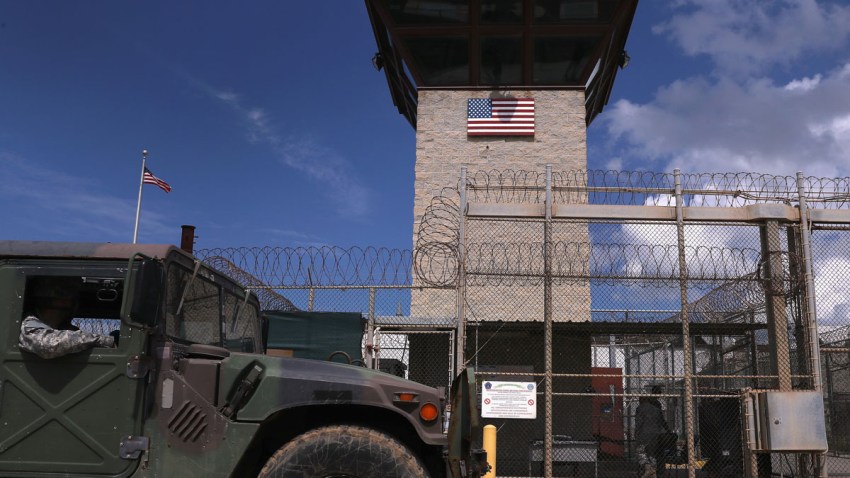 A humvee passes the guard tower guard tower at the entrance of the U.S. prison at Guantanamo Bay, also known as "Gitmo" on October 23, 2016 at the U.S. Naval Station at Guantanamo Bay, Cuba.