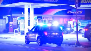 Dedham police are searching for two suspects after a clerk was shot during a robbery late Thursday night.