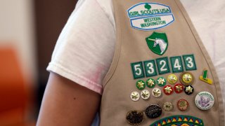 In this June 18, 2018, file photo, the vest of a Girl Scout is seen filled with badges and awards at a demonstration of some of their activities in Seattle.