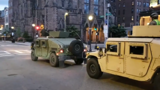 Massachusetts National Guard vehicles drive through Boston.