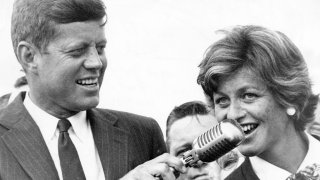 BOSTON, MA – JULY 17: Sen. John F. Kennedy (left) and Jean Kennedy Smith (right) speak to a large crowd of people at Logan Airport in Boston on July 17, 1960. The crowd welcomed him home and cheered him on after he became the Democratic nominee for President of the United States.  (Photo by Phil Preston/The Boston Globe via Getty Images)